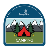 Tent with mountains and trees behind it.