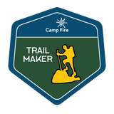 Silhouette of a person hiking a trail.
