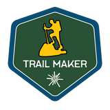 Silhouette of a person hiking a trail.